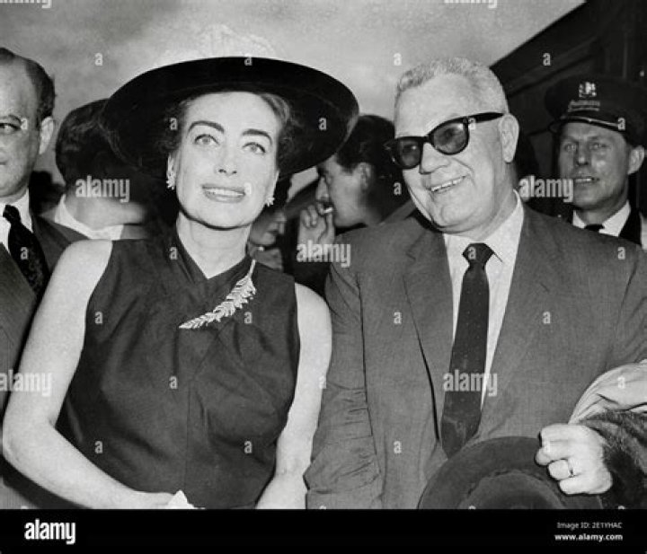 Joan Crawford and her husband Alfred Steele share wedding cake, May 13, 1955 Stock Photo Alamy