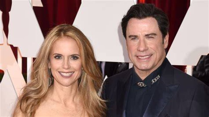 John Travolta embraced wife Kelly Preston on the red carpet. Vanity Fair's Exclusive Oscars